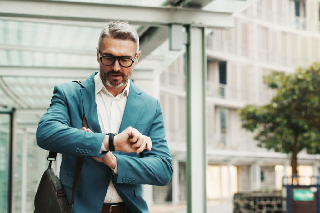 Businessman, worry or check watch in city for time management, agenda or late for meeting. Mature person, stress or wristwatch in town for commute schedule, interview appointment or missed deadline.