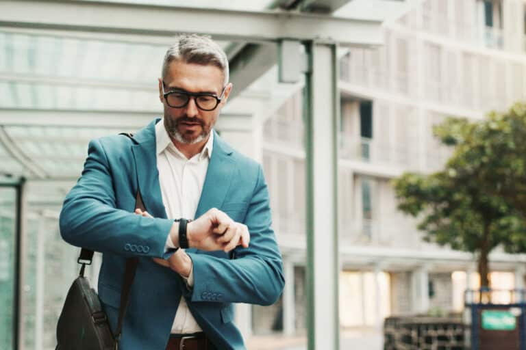 Businessman, worry or check watch in city for time management, agenda or late for meeting. Mature person, stress or wristwatch in town for commute schedule, interview appointment or missed deadline.