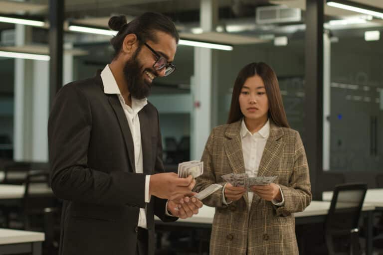 Arabian happy businessman with many money man count banknotes and sad Asian businesswoman woman with little finance salary in office money inequality equal pay discrimination cash business colleagues. High quality 4k footage